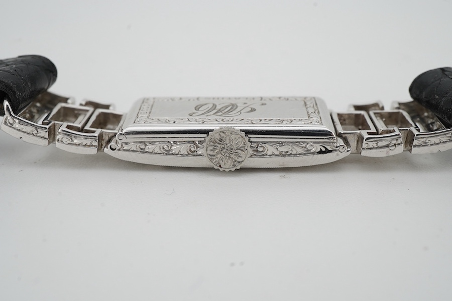 An Art Deco lady's diamond cocktail watch, 1930s, the rectangular silvered dial with blue steel hands, in a geometric case set with circular-cut and baguette diamonds, mounted in platinum, case width 1cm excluding winder